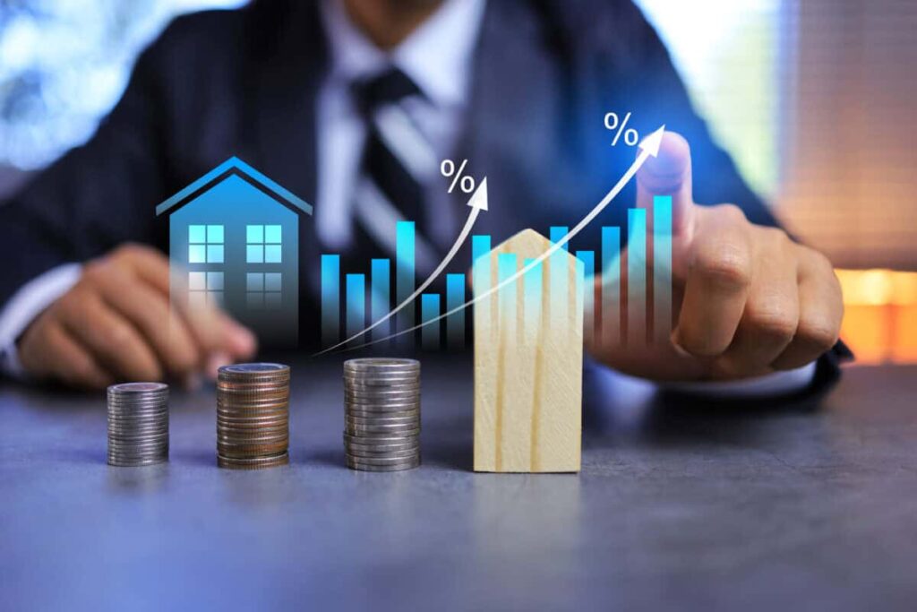 Here’s an 11% Dividend Stock That Pays Out Monthly Real estate investment concept with person pointing on growth graph and coin stacking to get profit from property