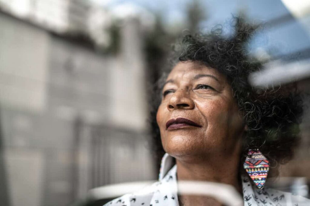 Dividend Income in Retirement: What Could Go Wrong? woman gazes forward out window to future