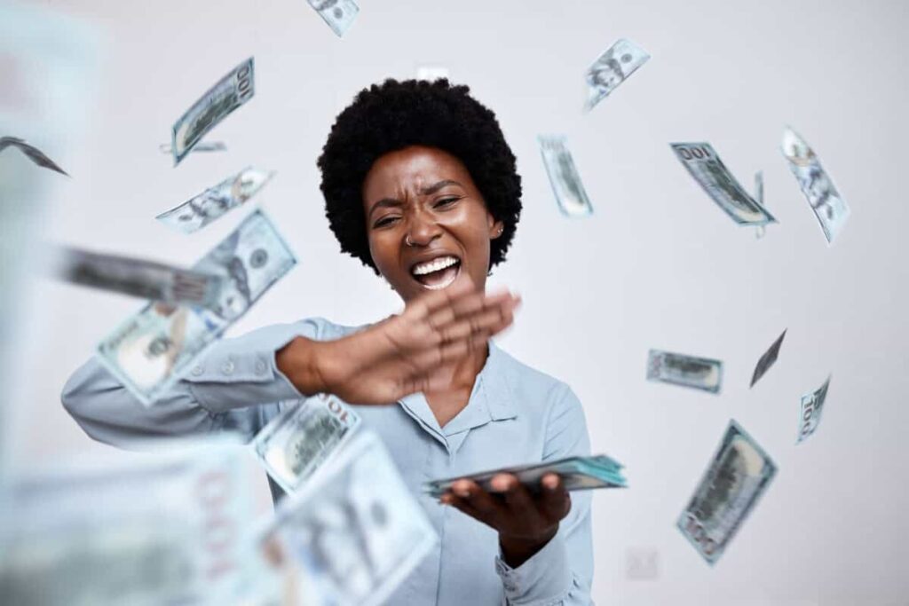 The Ideal TFSA Stock: A 5.9% Yield-Paying Constant Cash happy woman throws cash